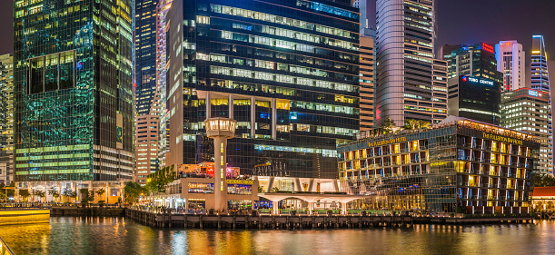 The neon lights and colourful glow of the restaurants, skyscrapers and hotels of Singapore's Central Business District reflecting in the still waters of Marina Bay. ProPhoto RGB profile for maximum color fidelity and gamut.