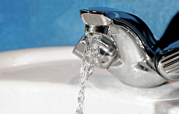 istock Water tap with flowing water. Selective focus, shallow depth of 530395367