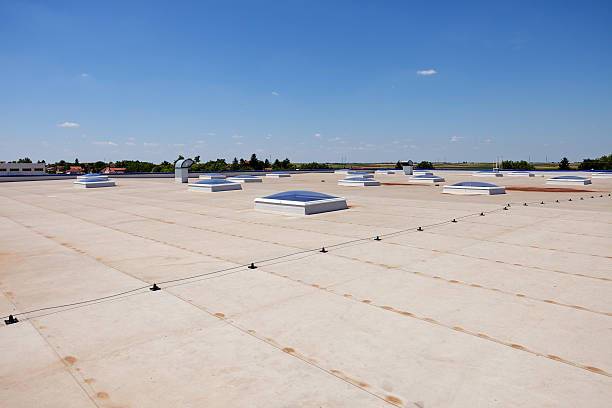 flat roof on industrial hall Flat roof with skylight and hydro insulation membranes cladding construction equipment photos stock pictures, royalty-free photos & images