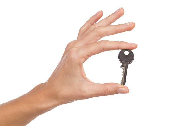 istock Woman hand's holding a key. 530405529