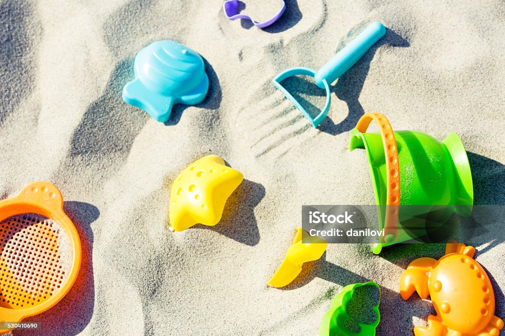 Colorful baby sand toys on the beach Toy Stock Photo