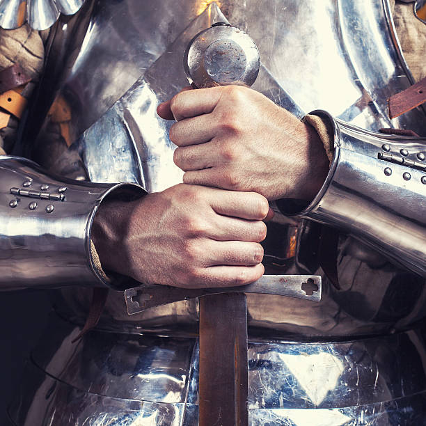 istock knight wearing armor and holding two-handed sword 530410974