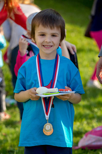 istock Proud preschool boy, holding prizes and medals 530412588