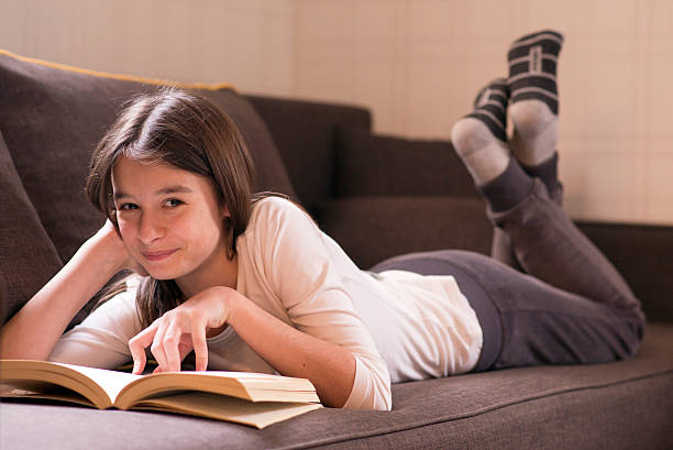 istock Little Girl Reading Book 530412632