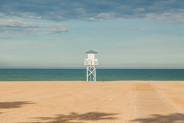 istock Lifeguard white wood post in the beach. 530413266