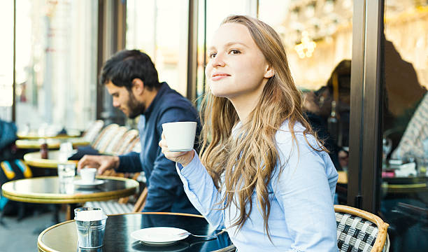 istock Young Woman Enjoying Coffee in a Sidewalk Cafeteria 530413964