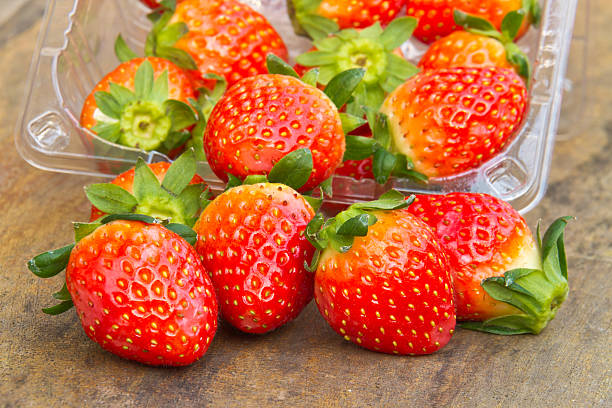 istock Close up of fresh strawberries on the table inside plastic 530414261