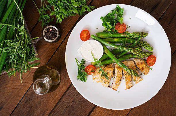 istock Baked chicken garnished with asparagus and herbs 530415292