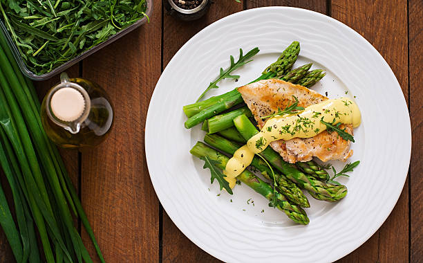 istock Baked chicken garnished with asparagus and herbs 530415492