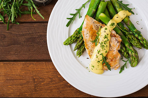 istock Baked chicken garnished with asparagus and herbs 530415598