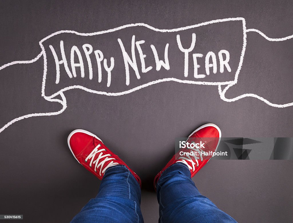 New year christmas concept New year christmas concept with red sneakers and white chalk text on black floor 2015 Stock Photo