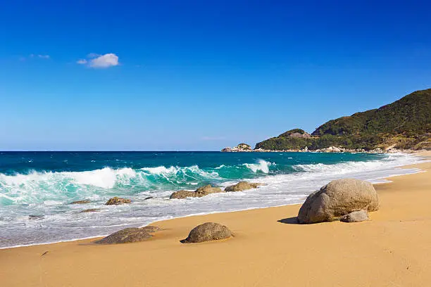 A beautiful beach on the subtropical island of Yakushima (屋久島), Japan. Photographed at the Nagata Beach on a bright day.