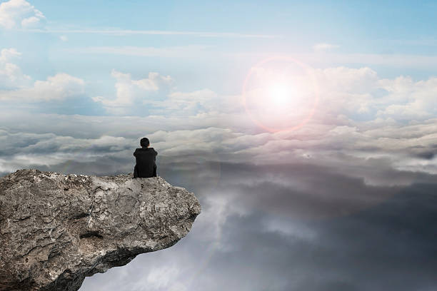 businessman sitting on cliff with natural sky daylight cloudscap businessman thinking and sitting on cliff with natural sky daylight cloudscape background reach destination stock pictures, royalty-free photos & images