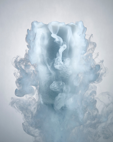 glass of water with dry ice vapor