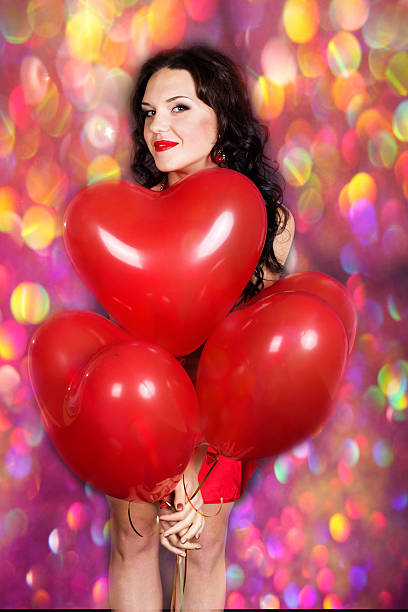 istock Sexy brunette with balloons heart 530417693