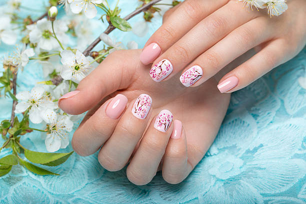 istock Spring manicure for the bride in gentle tones with flowers 530418120