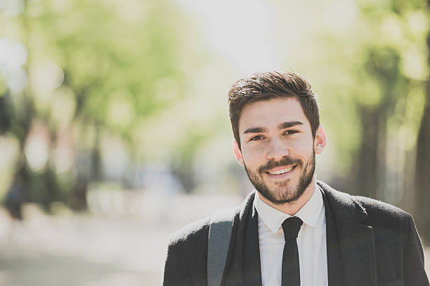 istock Portrait of a smart young man outdoors smiling 530418138