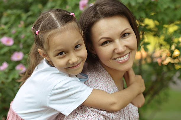 istock girl with mother in park 530421304