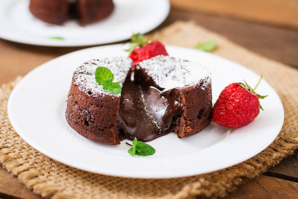 istock Chocolate fondant (cupcake) with strawberries and powdered sugar 530421394