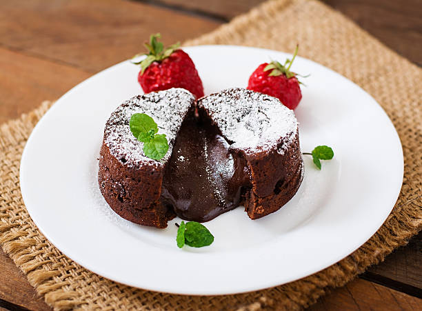 istock Chocolate fondant (cupcake) with strawberries and powdered sugar 530421710