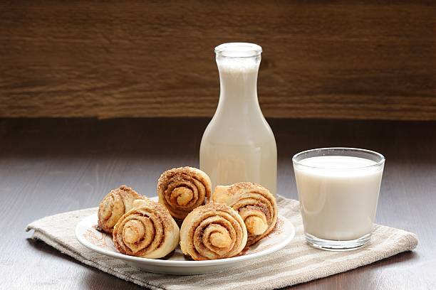 istock Cinnamon rolls with glass and bottle of milk 530423639