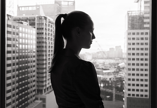 Thoughtful young business woman (black and white portrait).