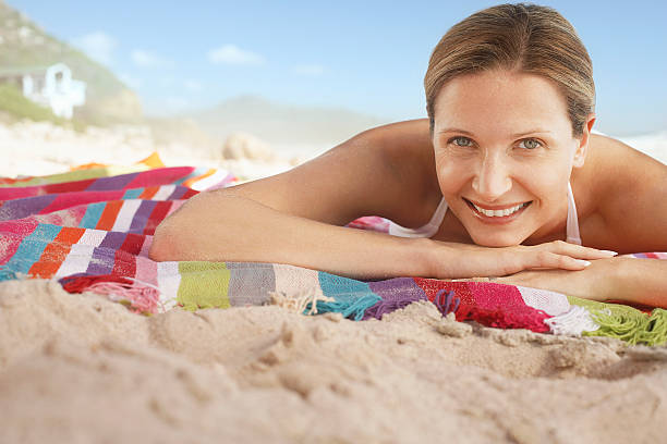 istock Happy Woman Lying On Blanket At Beach 530425425