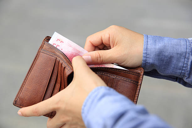istock Hands taking  money  out from wallet on the street 530425620