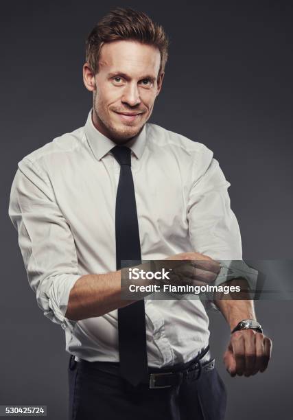 Handsome Businessman Rolling Up His Sleeves Stock Photo - Download Image Now - Sleeve, Rolling, Men
