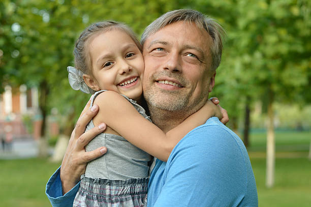 istock father with daughter in summer park 530425876