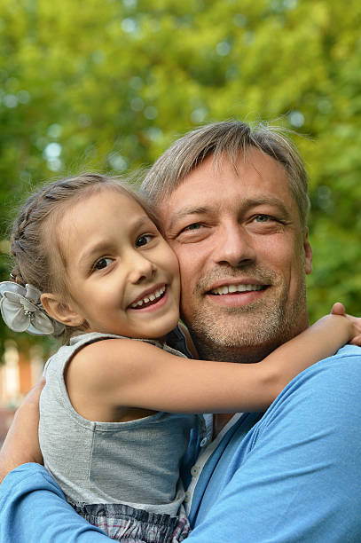 istock father with daughter in summer park 530426058