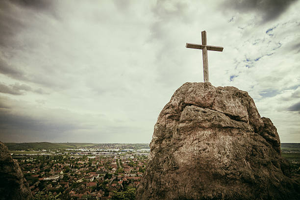 Cross on the rock stock photo