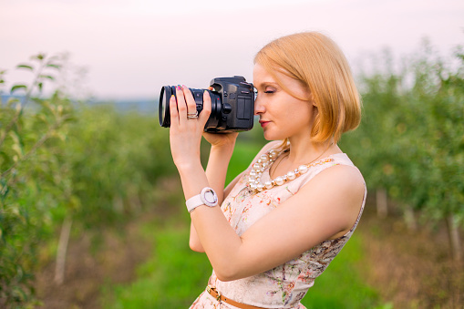 Girl photographing the surrounding landscape