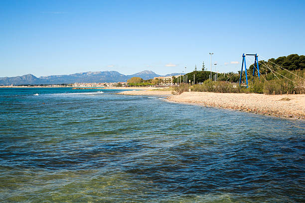 View of Cambrils seaside with bicycle bridge in foreground.