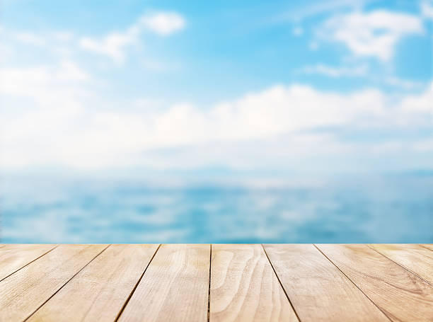 istock Wooden table top on blue sea and white sand beach 530427736
