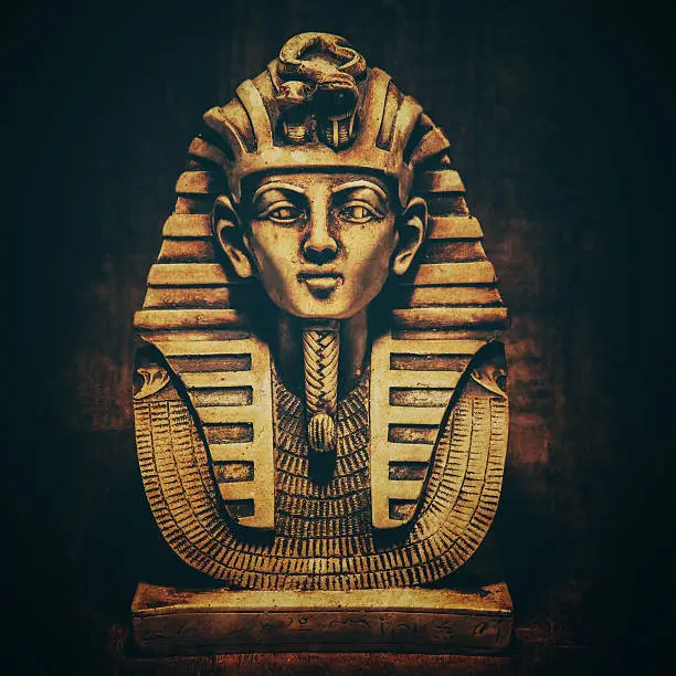 Stone pharaoh tutankhamen mask on papyrus background