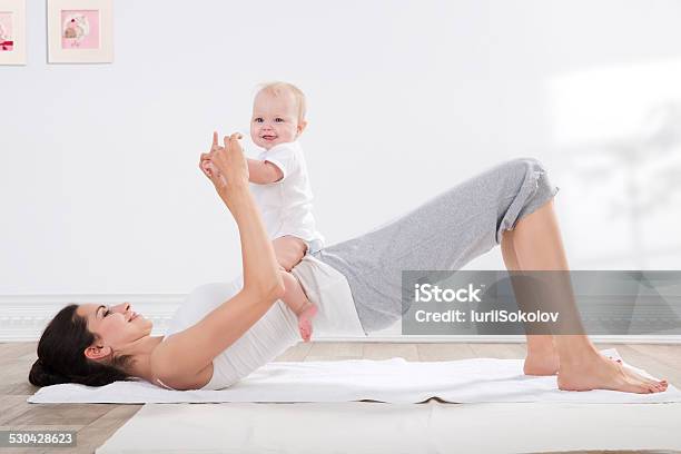 Mother And Baby Gymnastics Stock Photo - Download Image Now - Child, Exercise Mat, Family