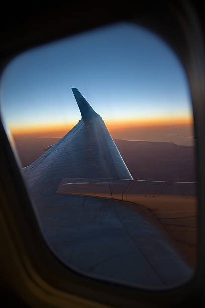 istock Wing of the plane on blue sky 530429490