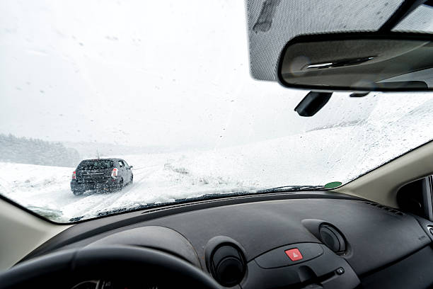 istock Snowfall,Country Road driving 530430157