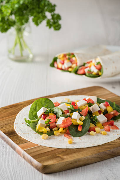 Vegan Tofu Wraps With Pepper Corn Tomatoes And Spinach Stock Photo ...