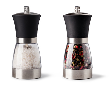 Salt and pepper grinder on white background