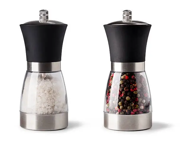 Salt and pepper grinder on white background