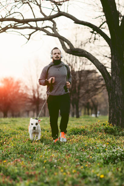istock Man Jogging With His Dog. 530432420