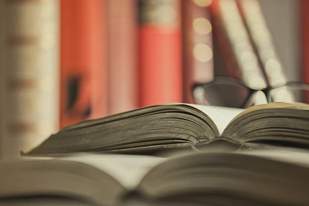 istock Glasses are laying on a book 530433357