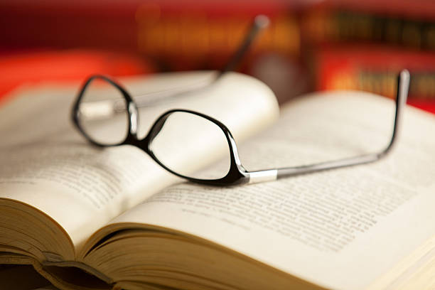 istock Glasses are laying on a book 530433519