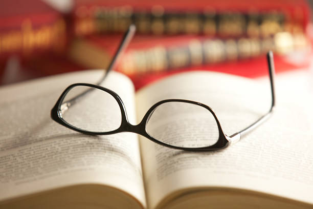 istock Glasses are laying on a book 530433565