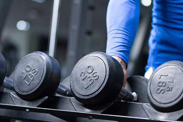 istock young asian man working out in modern gym 530433592