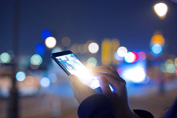 istock Woman using mobile phone at night street 530433964