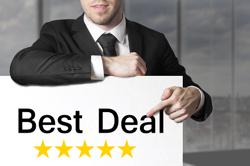 businessman in black suit pointing on white sign best deal rating stars