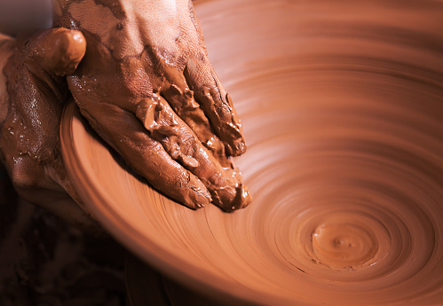 Hands of young potter, was produced on range of pot.